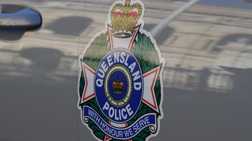 Close up of Queensland police logo on side of police car