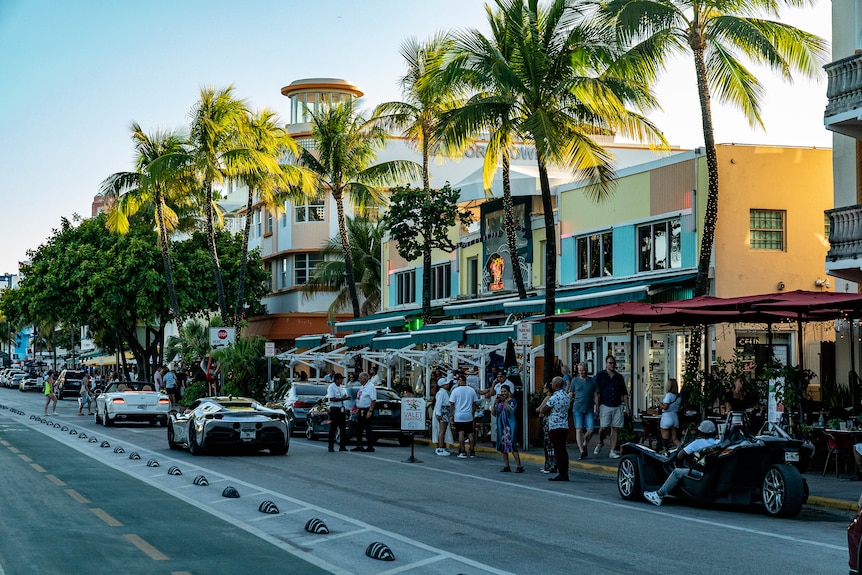 Cars drive down a Miami street.
