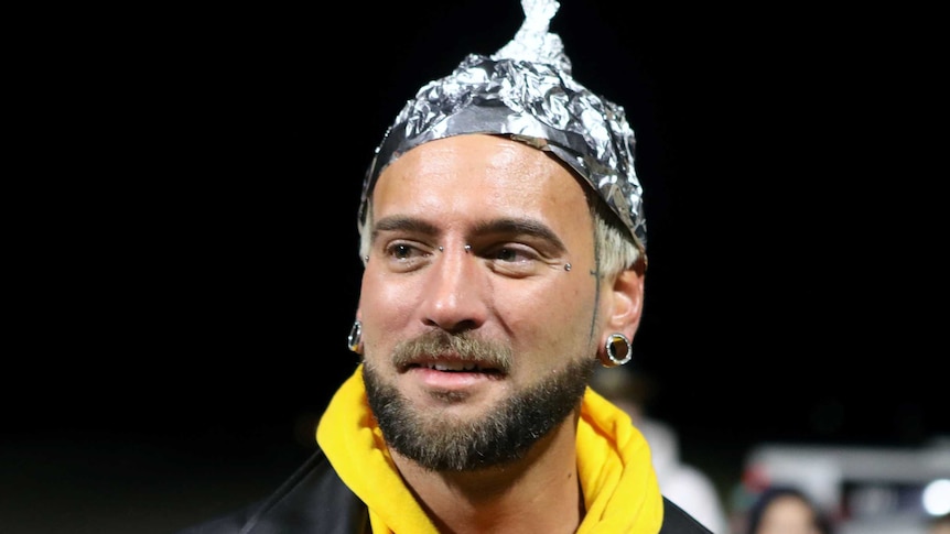 A man wearing a hat made of tin foil.