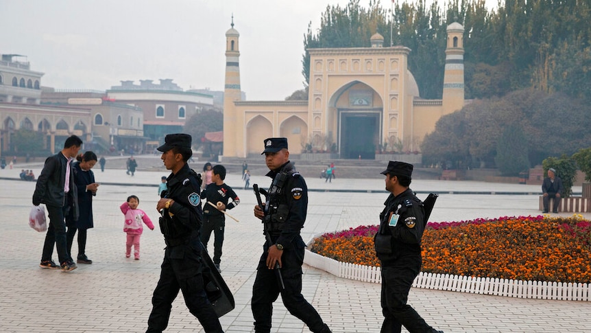Photo of Chinese military patrolling near a mosque in China's Xinjang region.