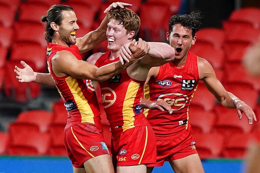 A smiling Matt Rowell is congratulated by Lachie Weller