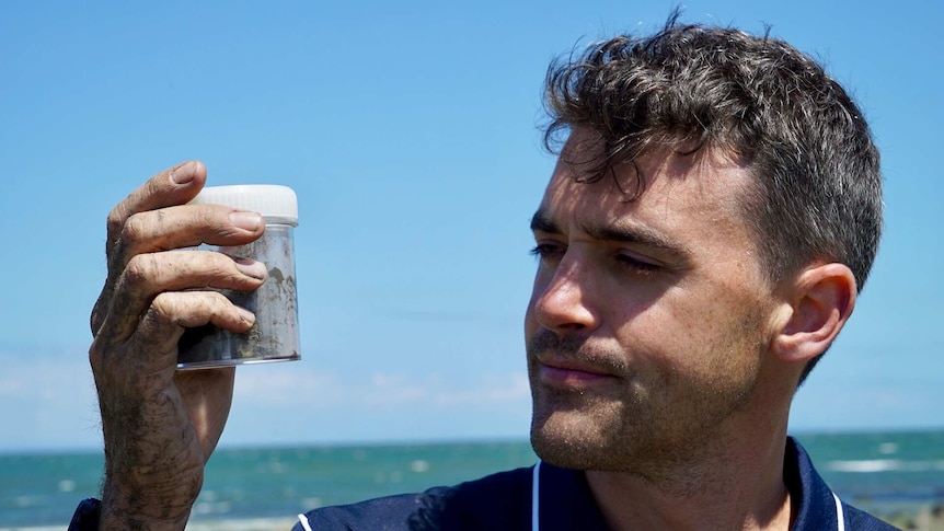Peter Macreadie with a sediment sample.