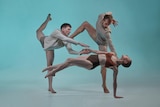 Three dancers contort their bodies to form a strange and connected shape against a green backdrop.