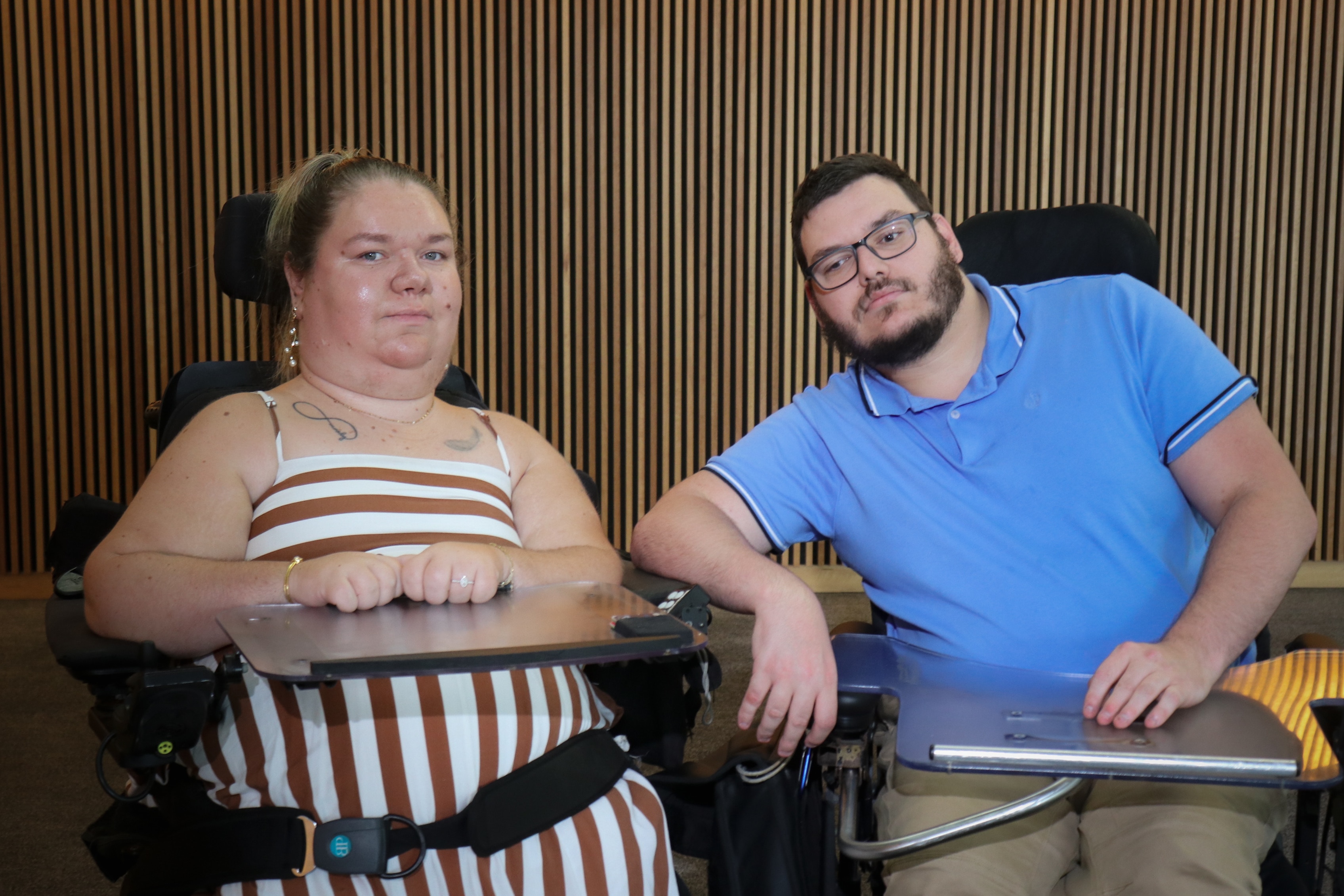 A woman and a man both in wheelchairs sitting next to each other