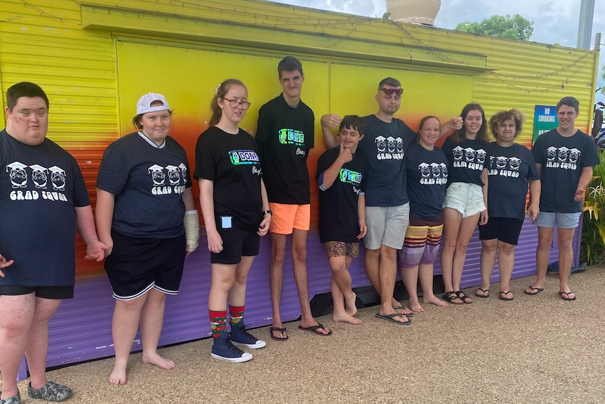 People stand in line and smile for photo at water park.