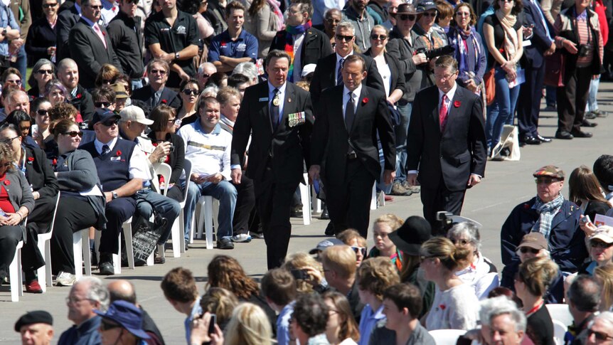Prime Minister Tony Abbott walks through the crowd at the Remembrance Day ceremony in Melbourne.