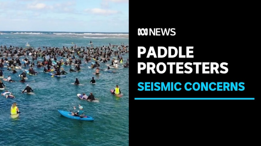 Paddle Protesters, Seismic Concerns: Hundreds of protesters sitting on surfboards in the water.
