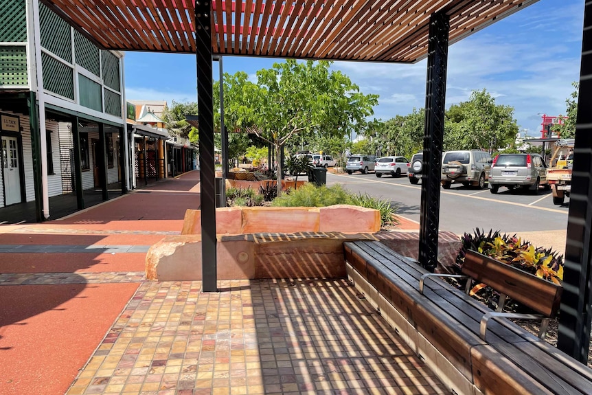 A street in Chinatown with benches.