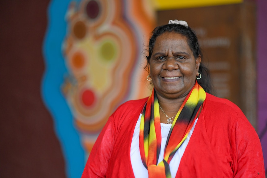 A woman smiles to camera