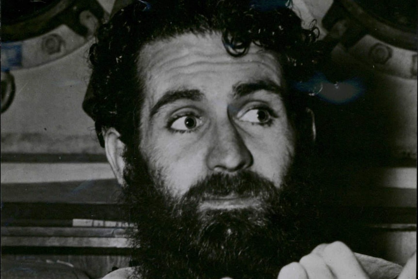 A black and white photo of Frank Weaver with dark hair and a heavy dark beard.