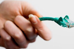 Hand with internet cable (Thinkstock:  Polka Dot)