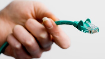 Hand with internet cable (Thinkstock:  Polka Dot)