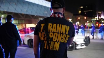 The back of a man's t-shirt reads Tyranny Response Team