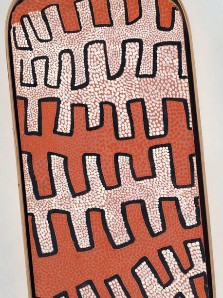 Ochre and cream dot with black out lines on oval shaped board from the early Papunya paintings of the 1970s