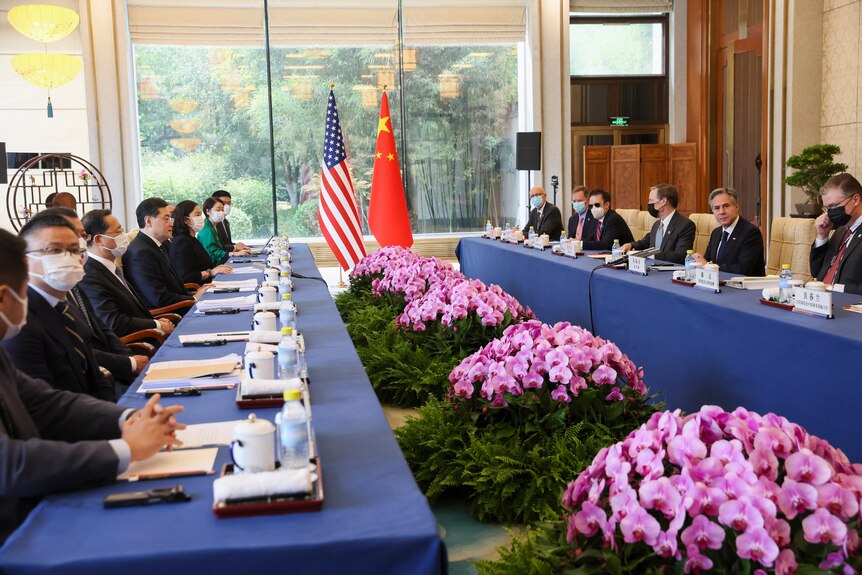 US and Chinese delegation sit down across from one another to meet at the Diaoyutai State Guesthouse in Beijing.