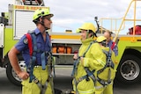 ABC News Canberra journalist Alkira Reinfrank learning safety instructions with ACT Fire and Rescue.