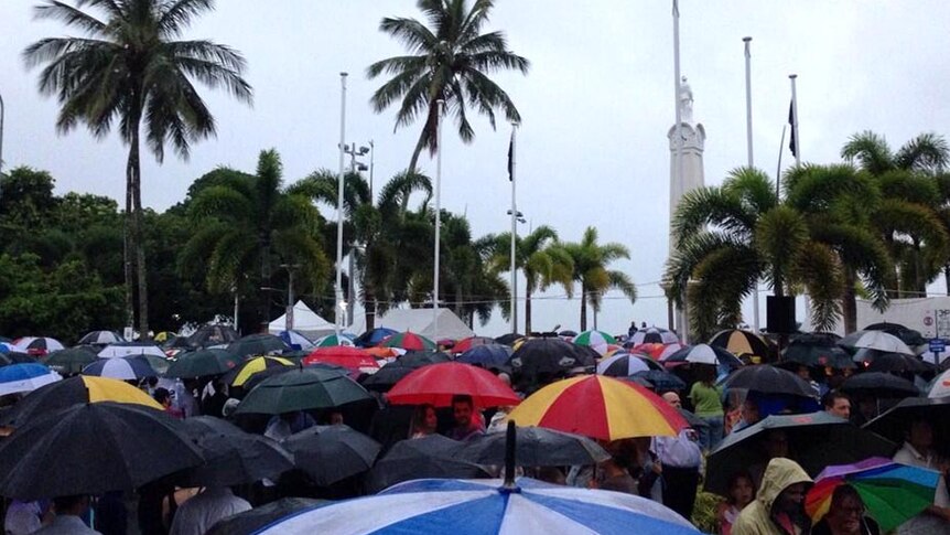 Crowds brave the rain to attend the Anzac Day dawn service in Cairns, far north Queensland.