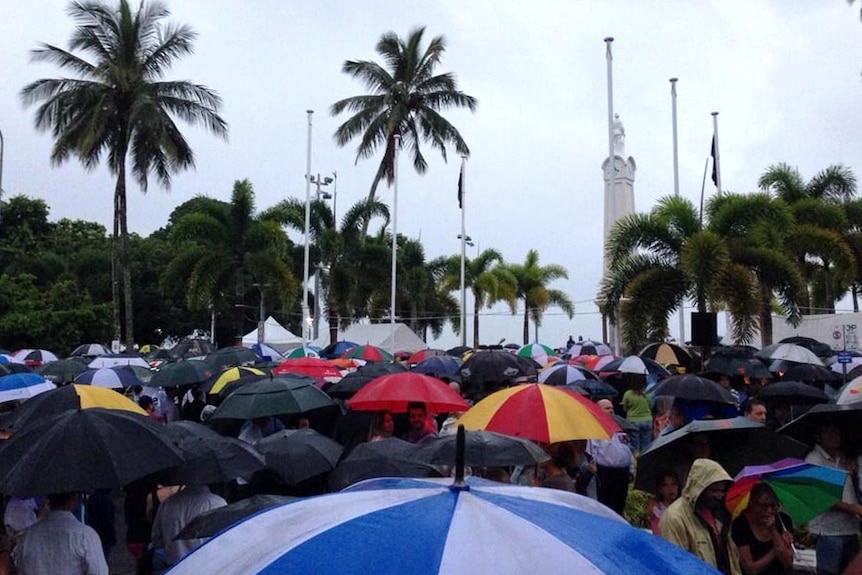 Crowds brave the rain to attend the Anzac Day dawn service in Cairns, far north Queensland.