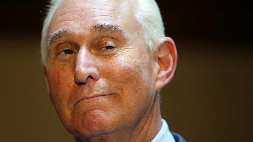 Roger Stone smiles at the camera.