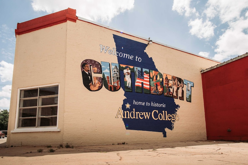 A mural on the side of a building reading 'welcome to Cuthbert'