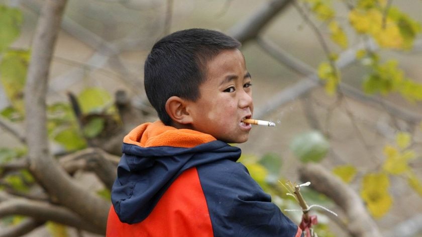 Chinese boy plays with firecrackers