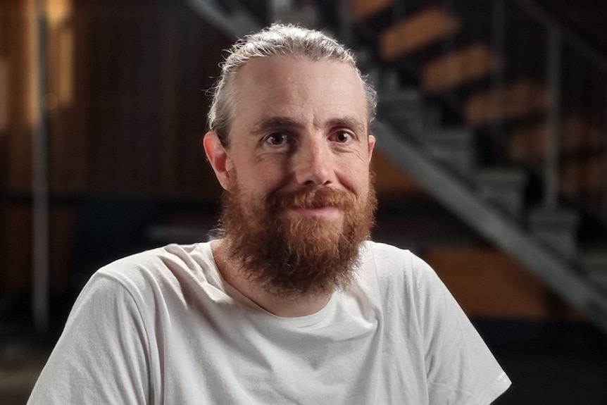 Mike Cannon-Brookes wearing a white shirt and smiling.