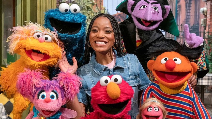 Keke Palmer with the Sesame Street characters