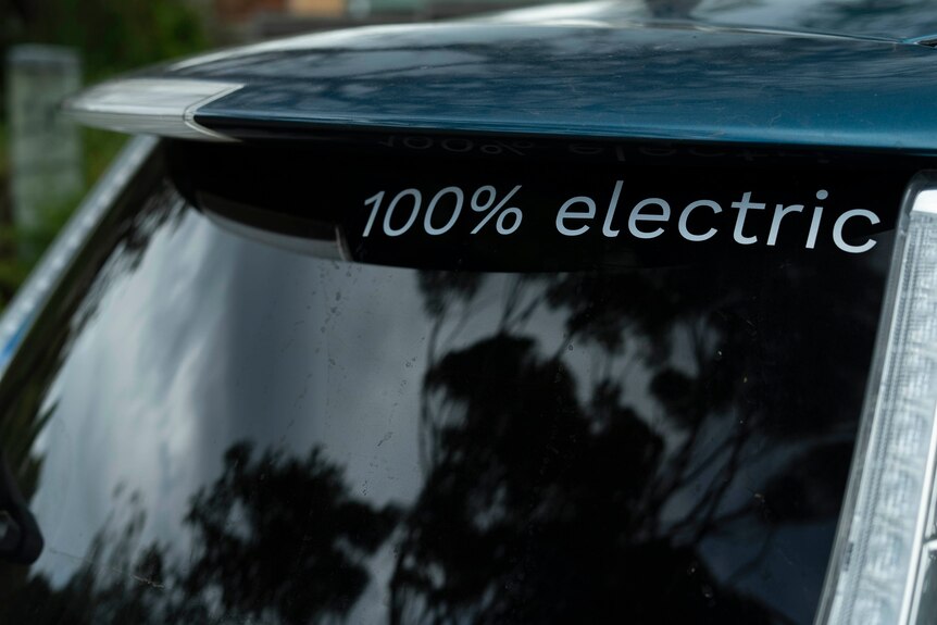 A sign on an electric car reads 100 per cent electric