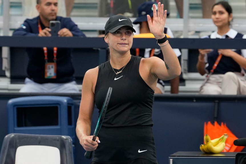 Aryna Sabalenka waves to the crowd after defeating Paula Badosa at Miami Open.