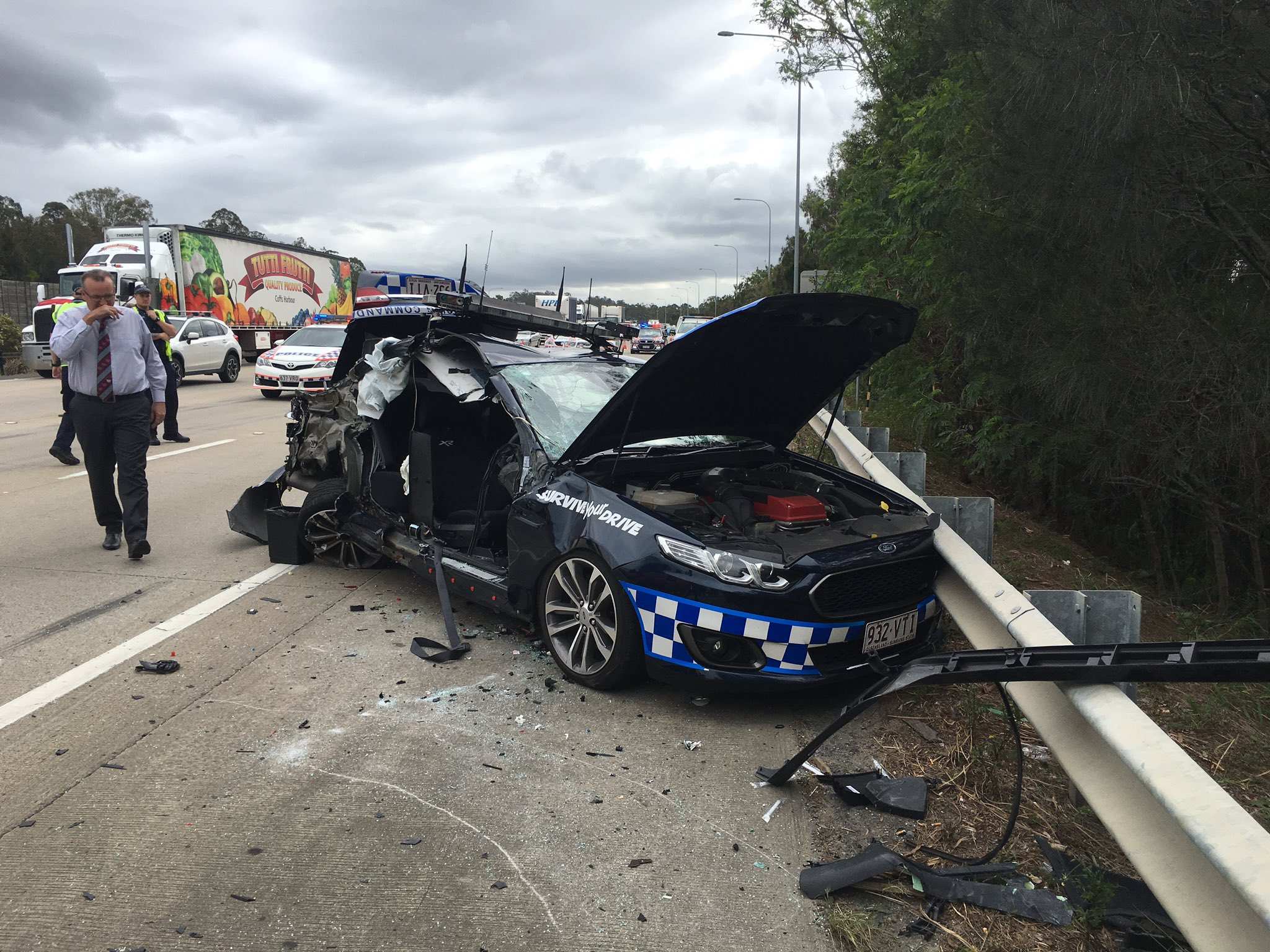 Queensland police officer injured as truck crashes into patrol car on