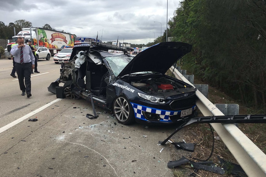 A badly damaged police car with doors torn off.