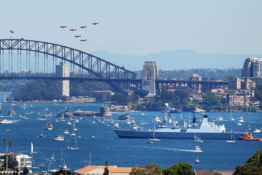 The RAAF Roulettes fly a warship in Sydney Harbour participating in the International Fleet Review.