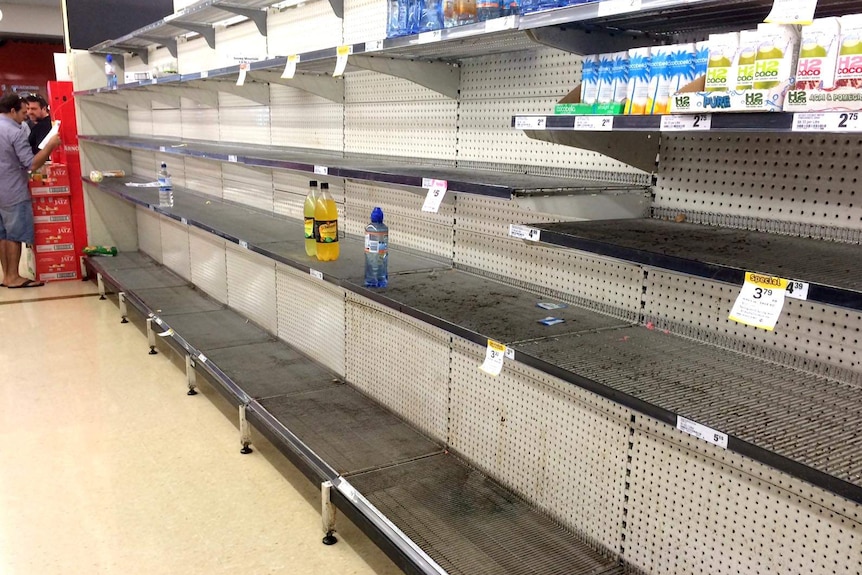 A few bottles remain on the shelves at Smithfield Woolworths ahead of the arrival of Cyclone Ita.