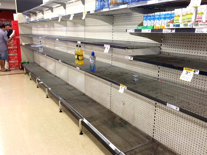 A few bottles remain on the shelves at Smithfield Woolworths ahead of the arrival of Cyclone Ita.