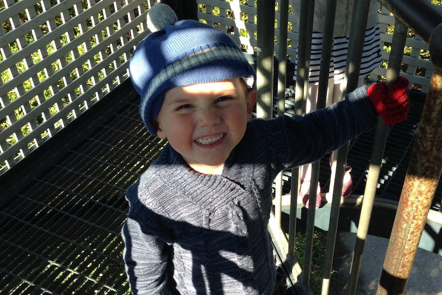 William Tyrrell smiles wearing a beanie