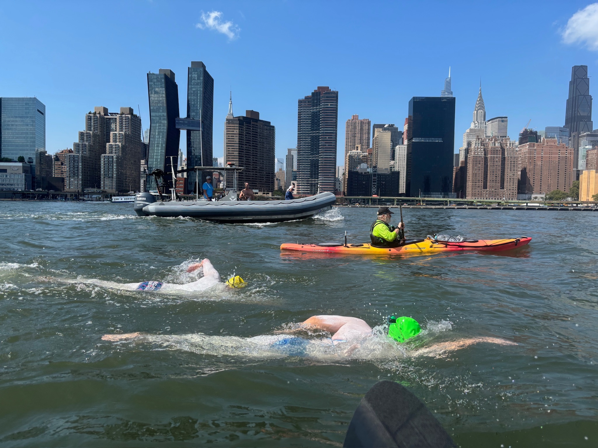 Swimmers with New York City in the backdrop.