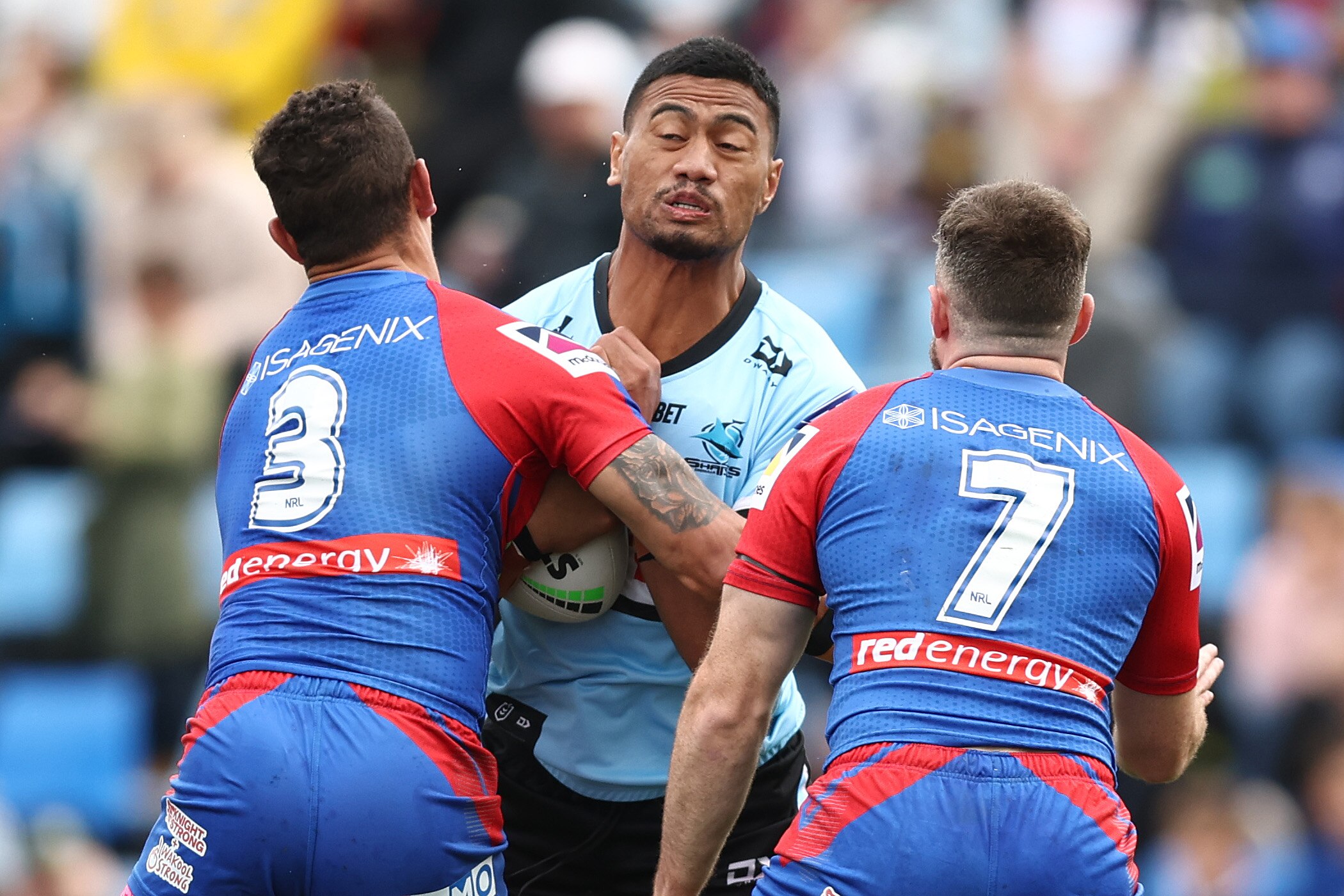 A Cronulla Sharks NRL player makes a hit-up against Newcastle Knights.
