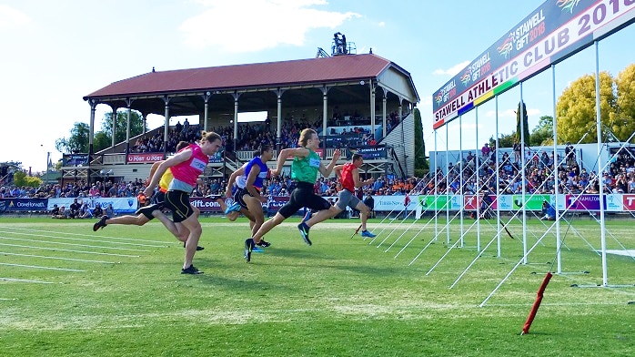 Male runners cross the finish line in the Stawell Gift in Western Victoria