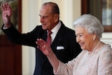 Queen Elizabeth and Prince Philip wave