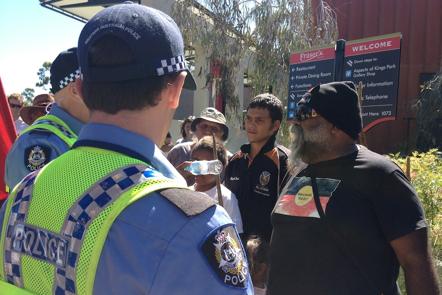 Police intervene as a protester swears