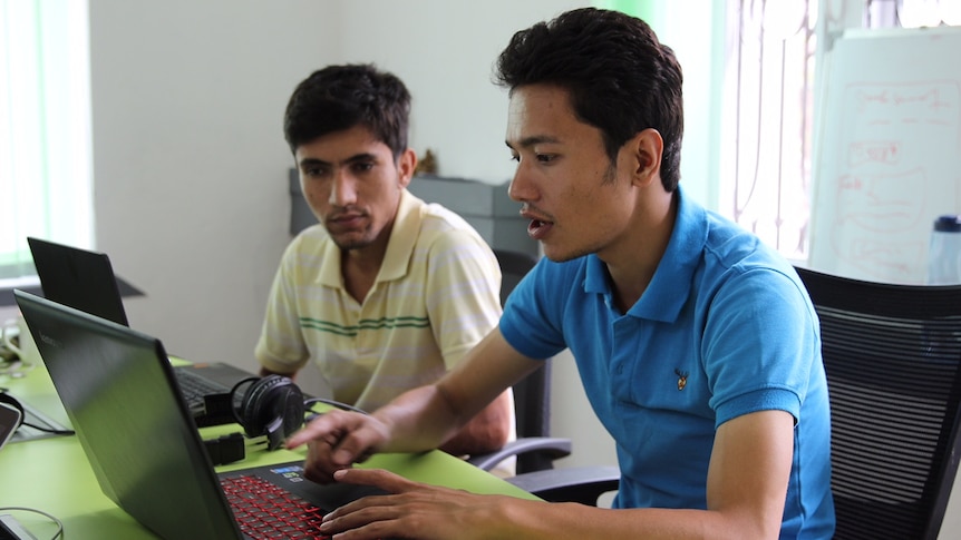 Sazal Sthapit and Pujan Poudel work on Quakemap.org