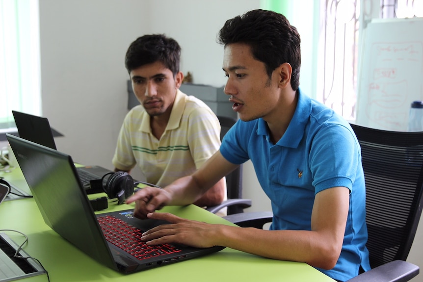 Sazal Sthapit and Pujan Poudel work on Quakemap.org