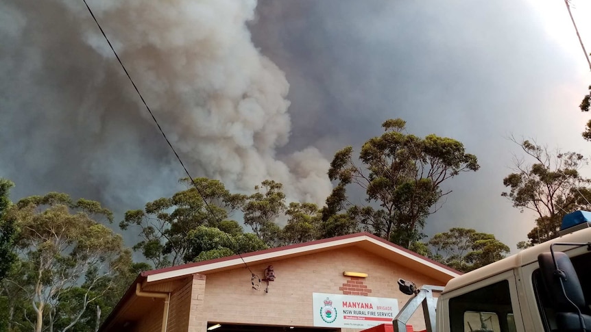 Smoke clouds linger over a building.