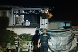 Policeman approaches a house