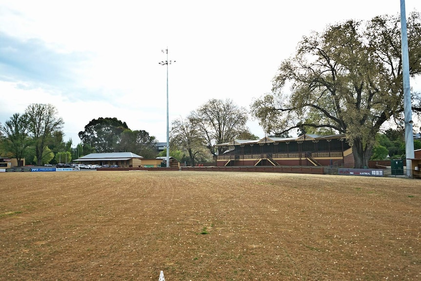 An empty football field with a grandstand at one end