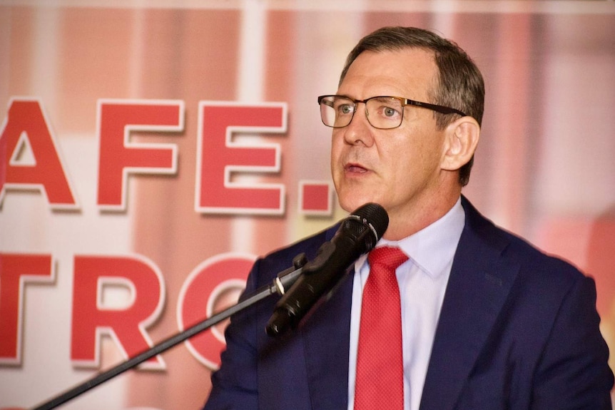 A photo of NT chief minister Michael Gunner delivering a speech at a lectern.