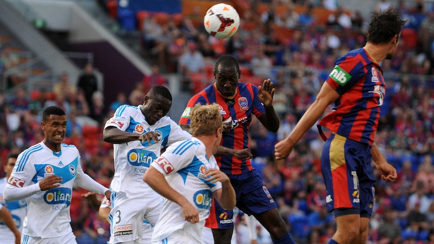 Newcastle's Heskey heads the ball against Victory