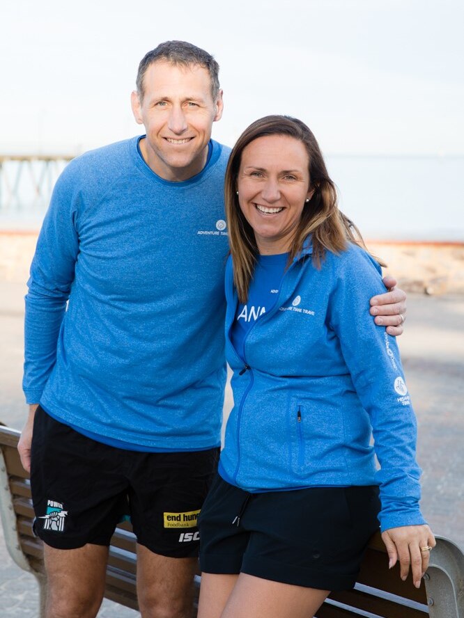 A man and a woman wearing running gear.