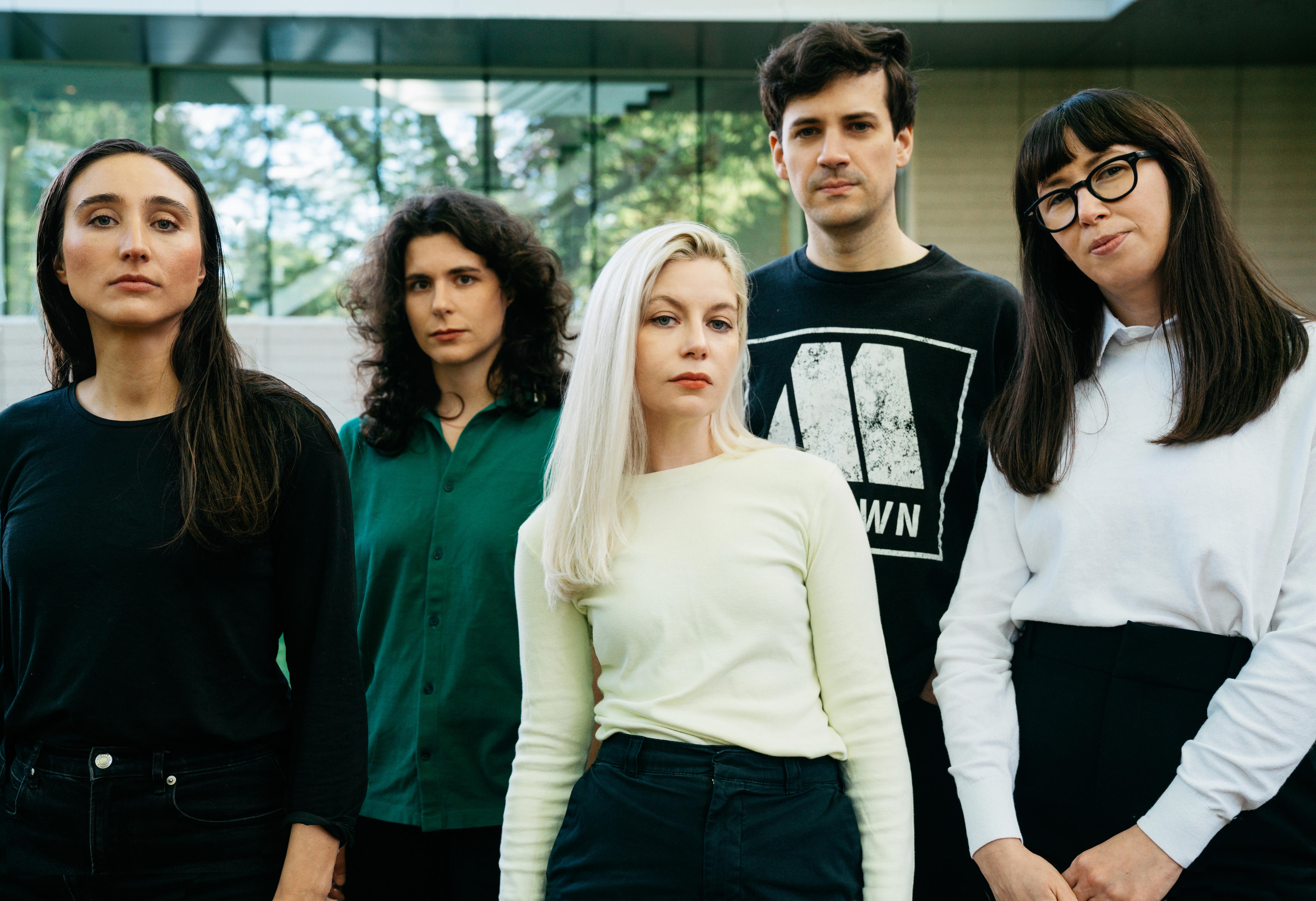 Five members of a band pose for a press photo.