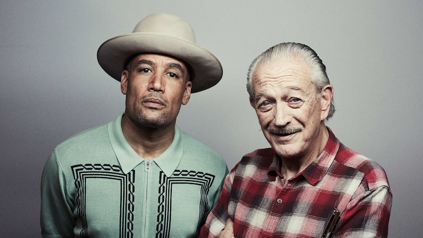 Ben Harper in Stetson hat and green shirt stands next to Charlie Musselwhite in a red checked shirt